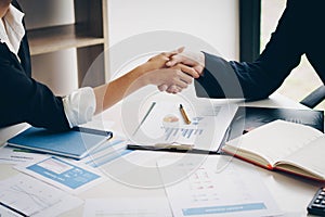 Businesswoman shaking hand for a complete business deal together photo