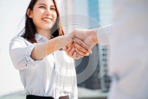 Businesswoman shaking hands with man