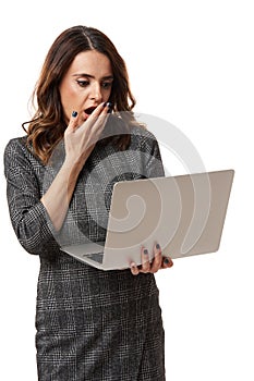 Businesswoman shocked looking at her laptop