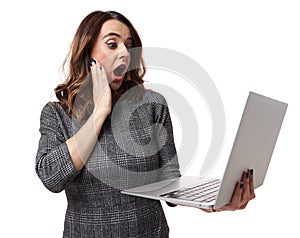Businesswoman shocked looking at her laptop