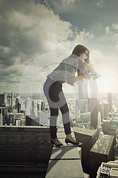 Businesswoman shouting with megaphone