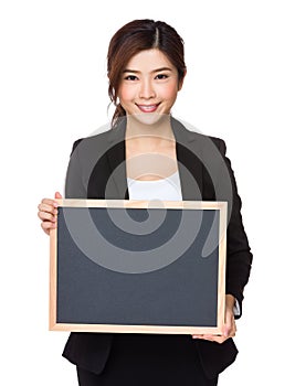 Businesswoman showing empty chalkboard