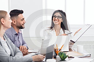 Businesswoman showing good statistics report at meeting photo