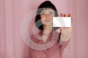 Businesswoman showing and handing a blank business card. Hands holding a white business visit card, gift, ticket, pass