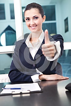 Businesswoman showing thumb up sign