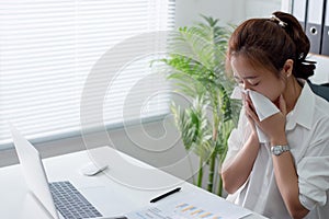 Businesswoman, She is sick and sneezing and coughing in the office