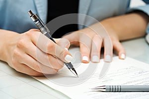 Business woman signing contract photo
