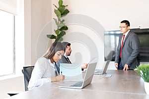 Businesswoman signing contract during meeting