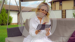 Businesswoman sits in backyard