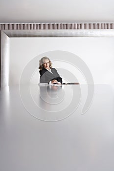 Businesswoman Sitting In Boardroom