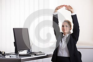 Businesswoman Sitting On Chair Stretching Her Arms