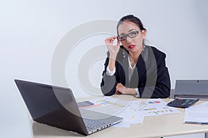 Businesswoman sitting at desk in office.