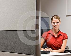 Businesswoman sitting at desk smiling