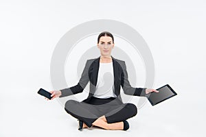 Businesswoman sitting with devices