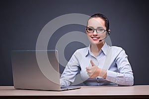 The businesswoman sitting at her desk in business concept