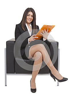 Businesswoman sitting looking documents