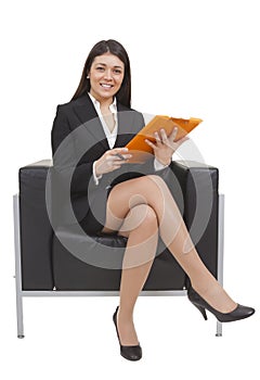 Businesswoman sitting looking documents