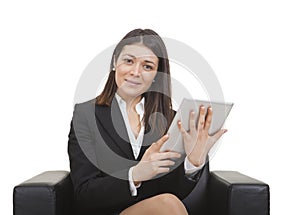 Businesswoman sitting looking tablet