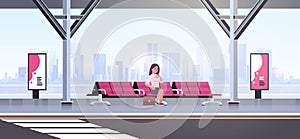 Businesswoman sitting modern bus stop business woman with suitcase waiting public transport on airport station cityscape