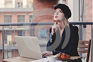 Businesswoman sitting near a table in breakfast time