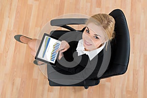 Businesswoman Sitting On Office Chair With Digital Tablet