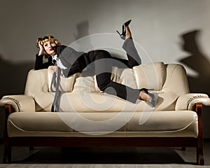 Businesswoman sitting on a sofa in office. stylized retro portrait