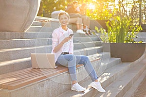 Businesswoman sitting stairs summer park using laptop Business persone working remote. Outdoor photo