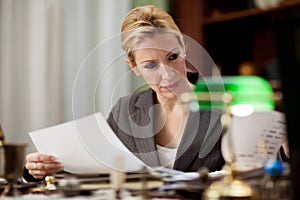 Businesswoman sitting at a table in the office and working