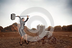 Businesswoman with sledgehammer photo