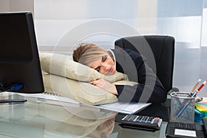 Businesswoman sleeping in office