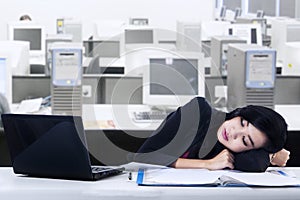 Businesswoman sleeping at workplace
