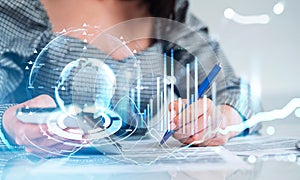 Businesswoman with smartphone in hands, financial bar chart and earth globe