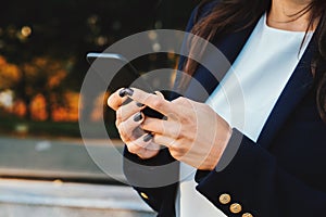 Businesswoman with smartphone. Student girl using cell phone. Beautiful woman in glasses surfing internet on mobile