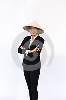 Businesswoman smiling in black suit and hat standing arms crossed