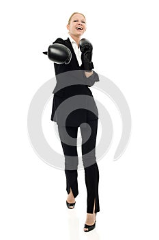 Businesswoman smiling with boxing gloves