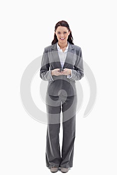 Businesswoman smiling while holding her mobile