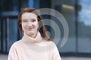 businesswoman, smiling mature middle aged woman. attractive lady posing in sunny day.