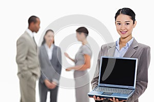 Businesswoman smiling showing a laptop screen