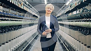 Businesswoman is smiling in the textile factory unit