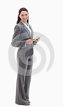 A businesswoman smiling with a touch pad
