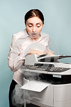 Businesswoman with smoking copier