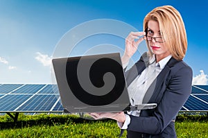 Businesswoman with solar power plant in background