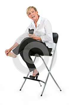 Businesswoman with sore feet sat on a chair