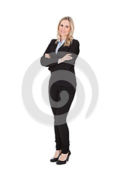 Businesswoman standing arms crossed over white background
