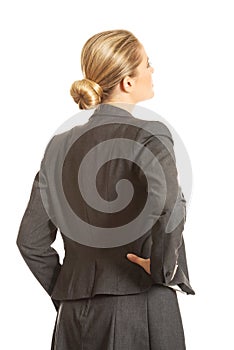 Businesswoman standing back with hand on hip