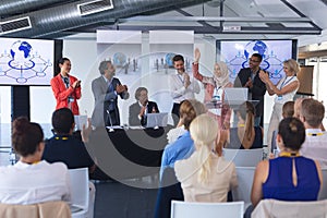 Businesswoman standing with colleagues and speaks in a business seminar