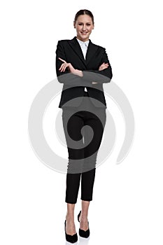 Businesswoman standing with crossed hands confident