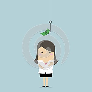 Businesswoman standing in front of a hook with a dollar sign as bait.