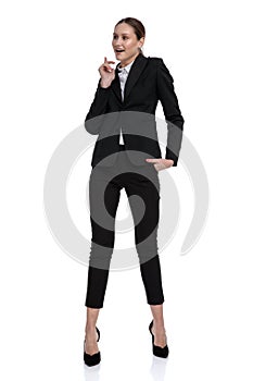 Businesswoman standing with hand in pocket and figuring something out