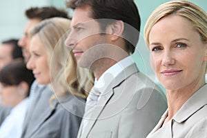 Businesswoman standing in a line